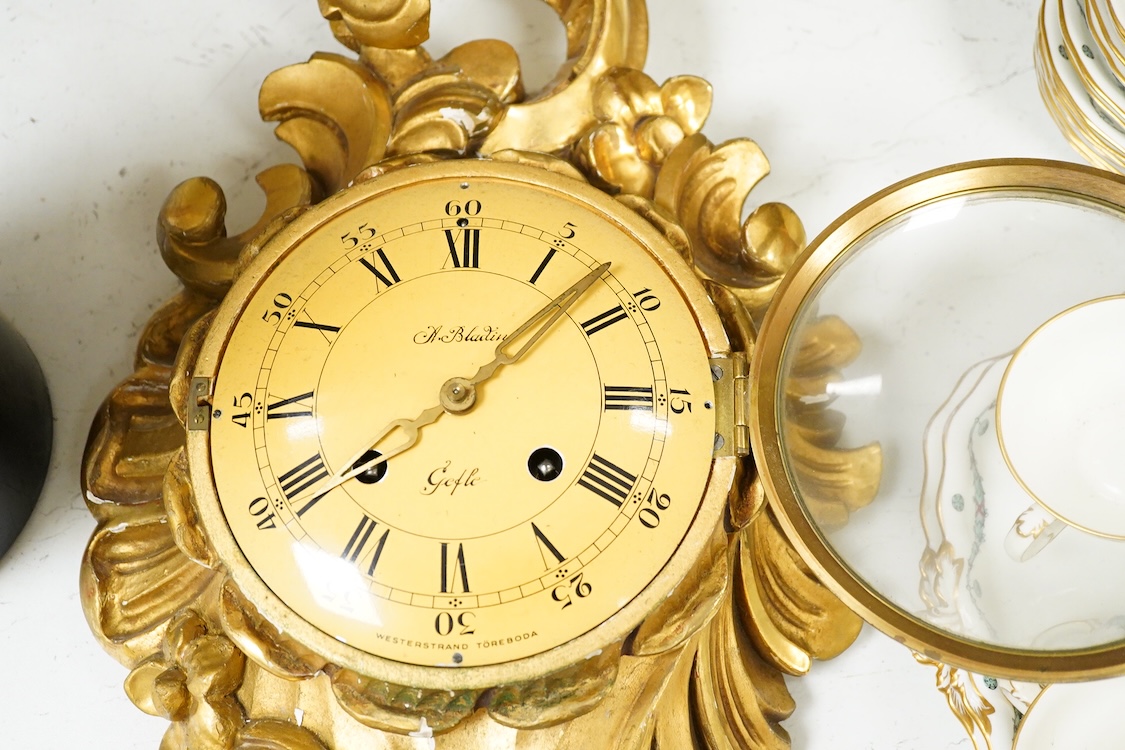 A carved giltwood cartel wall clock, 57 cm high